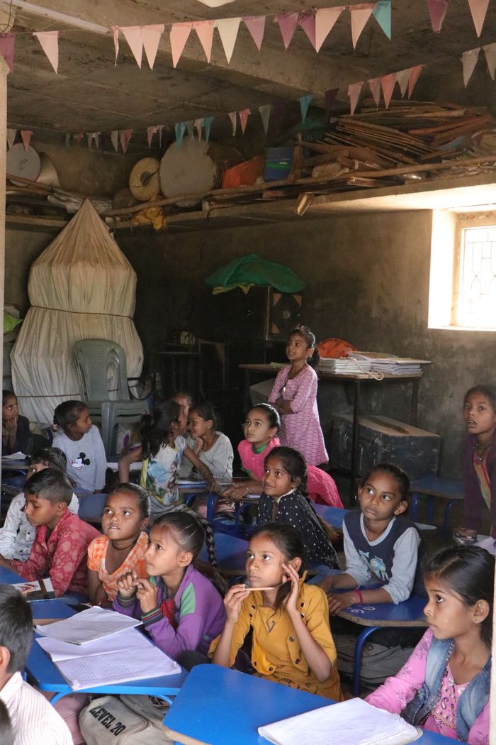 services-02 A group of children attentively learning in a rural classroom in Banaskantha, India.