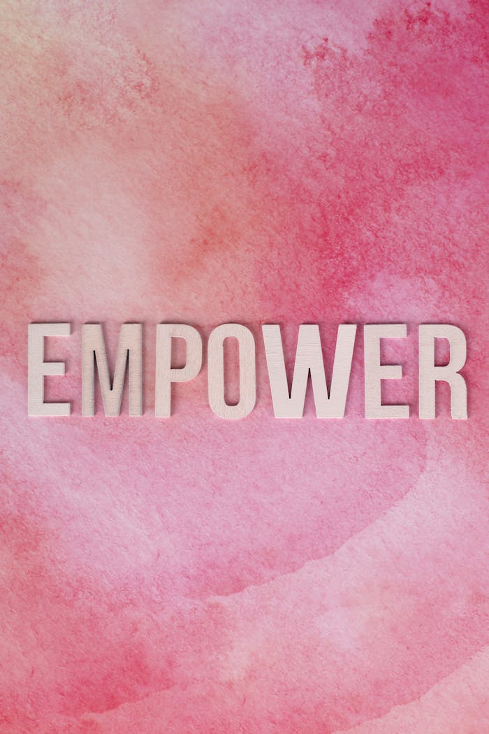 services-01 Inspiring message 'EMPOWER' on a pink watercolor texture, symbolizing strength and positivity.